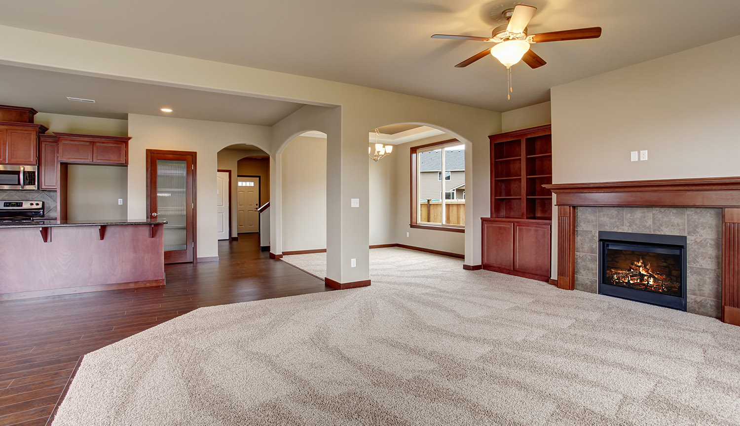 Lovely unfurnished living room with carpet.